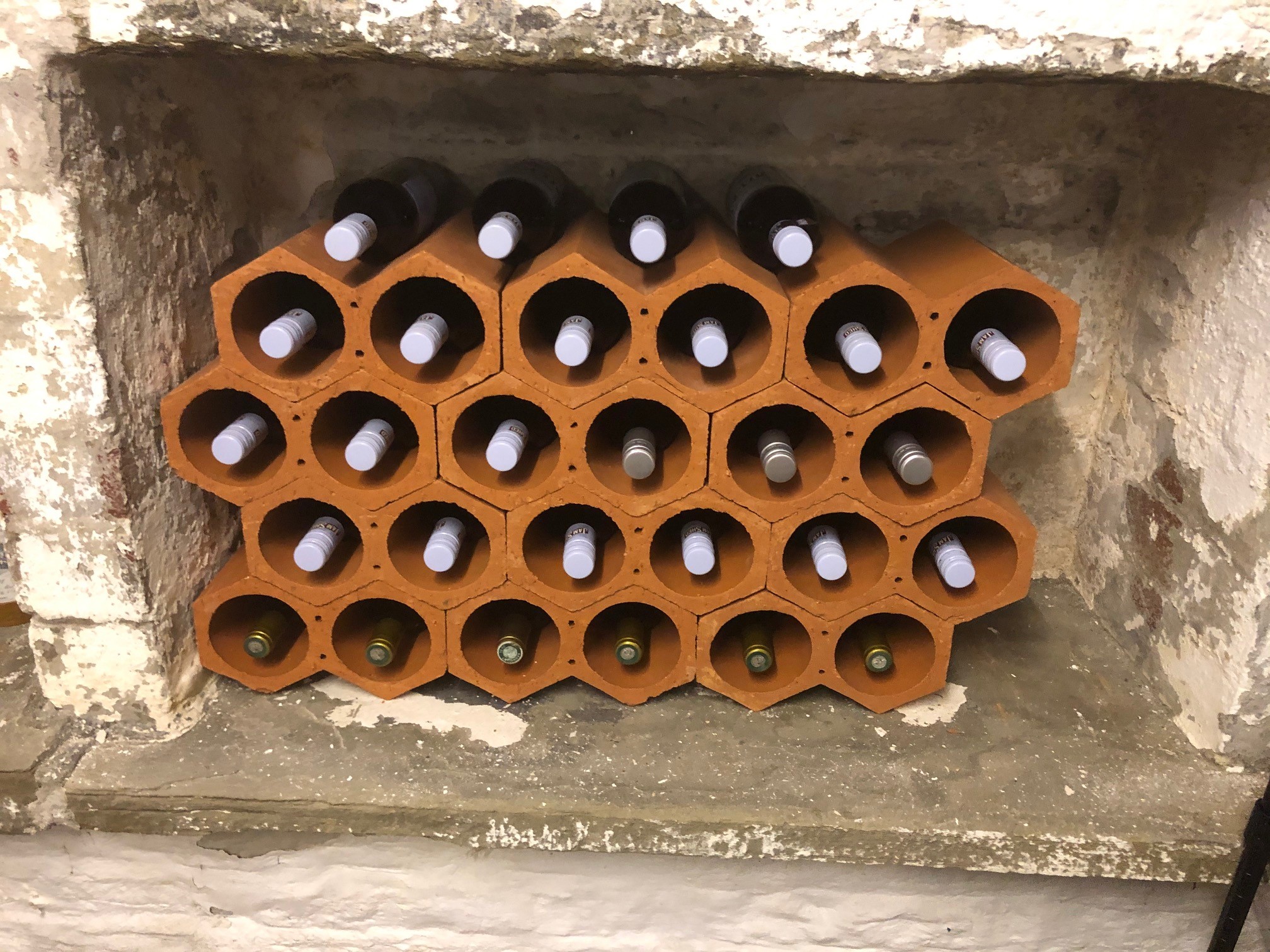 12 wine racks in rustic stone cellar