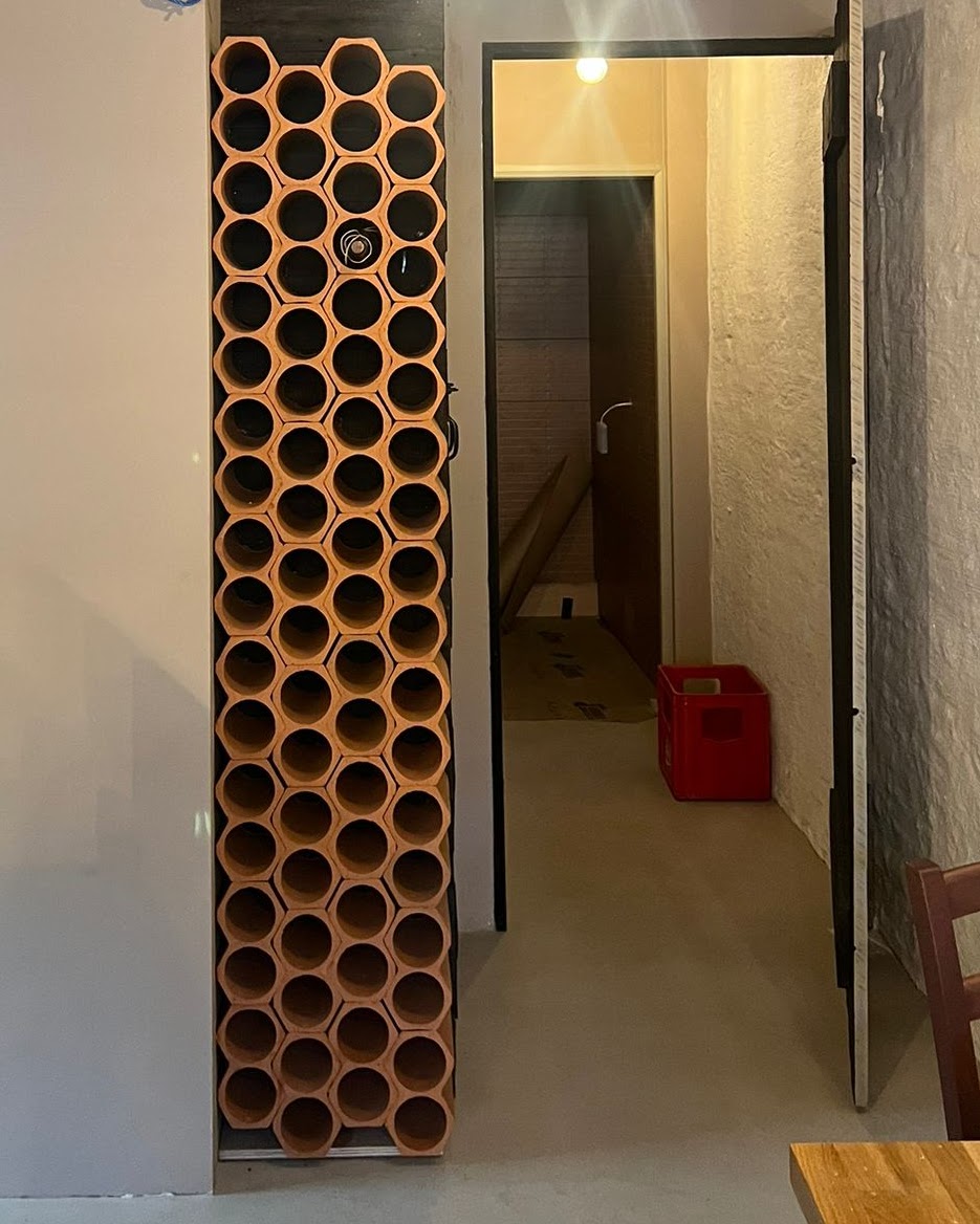 Floor to ceiling wine rack column in Greek restaurant