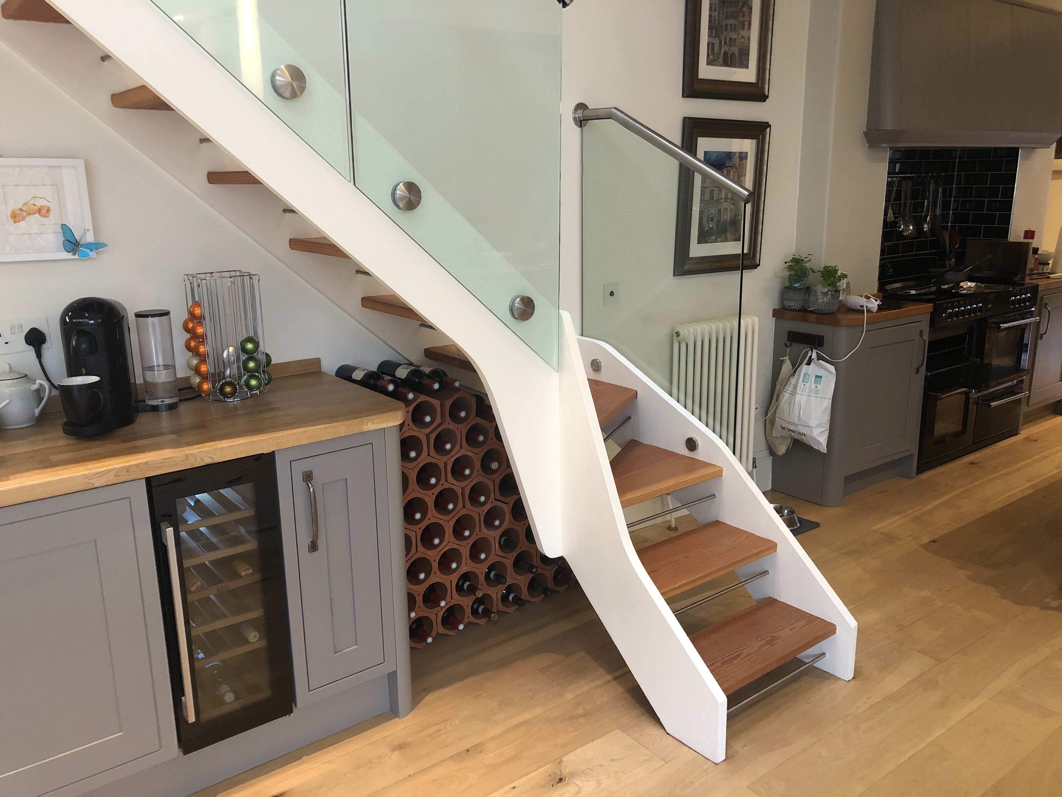 Under-stairs modern kitchen wine rack installation
