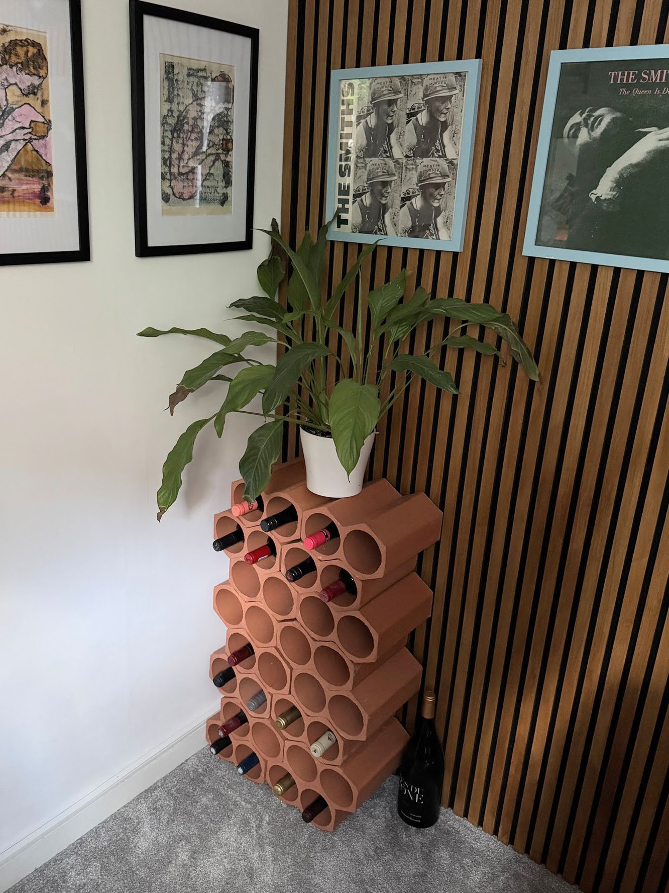 Freestanding wine racks against wood slatted wall