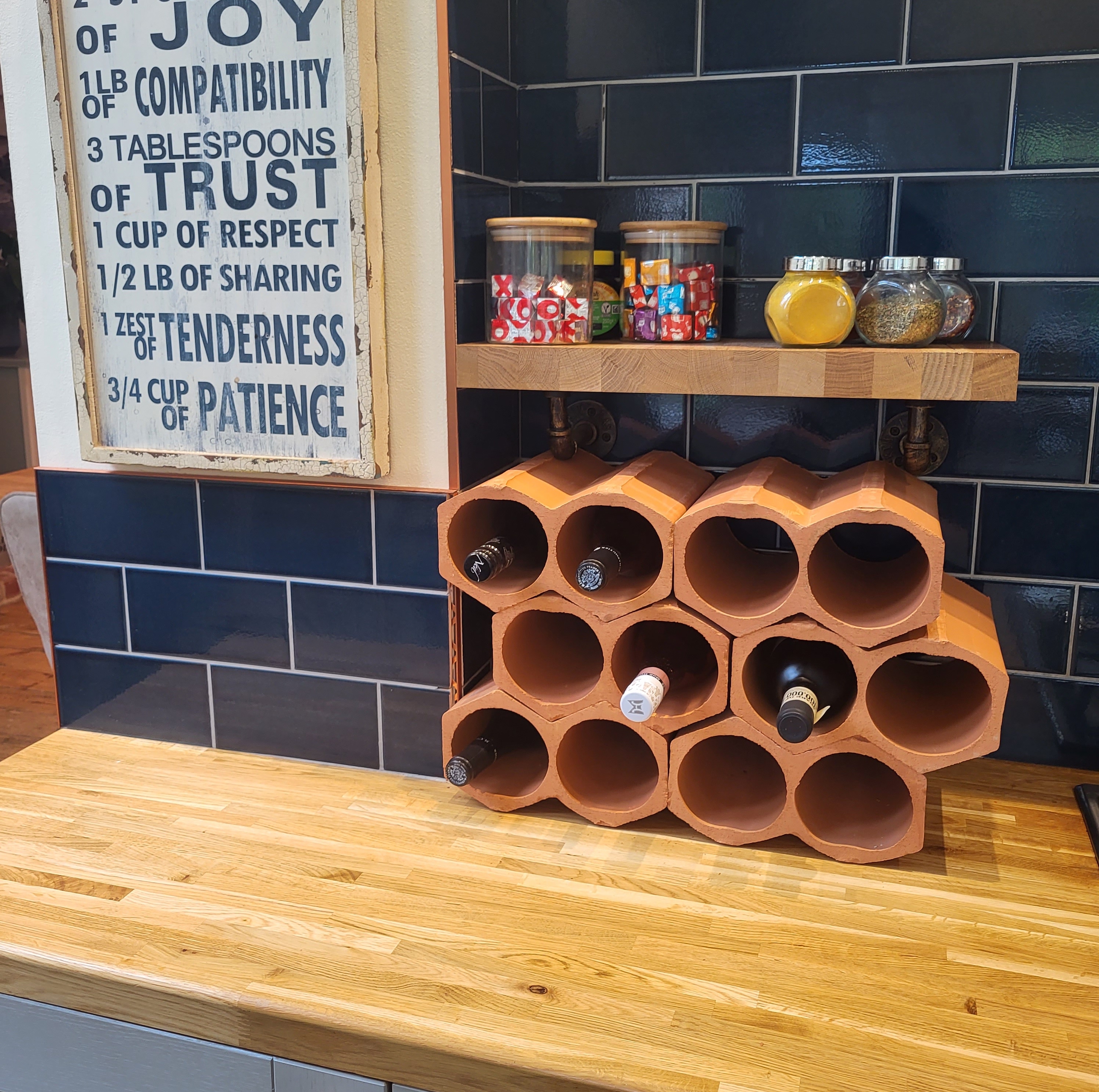 Wine racks on kitchen worktop with blue tiles